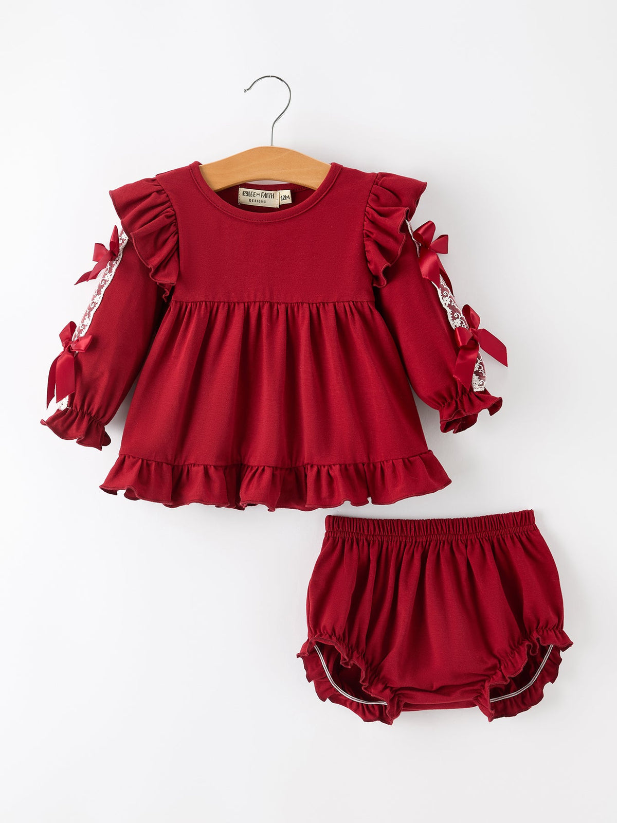 Baby girls' red Christmas set with lace-trimmed long-sleeve top, satin bows, ruffle shoulders and hem, and matching bloomers