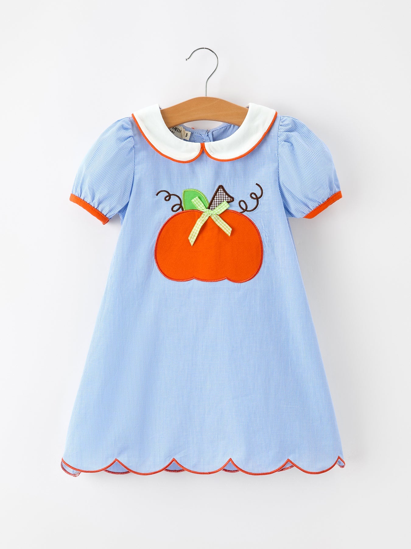 Light blue plaid girls dress with orange pumpkin applique, green bow, white Peter Pan collar with orange piping, puff