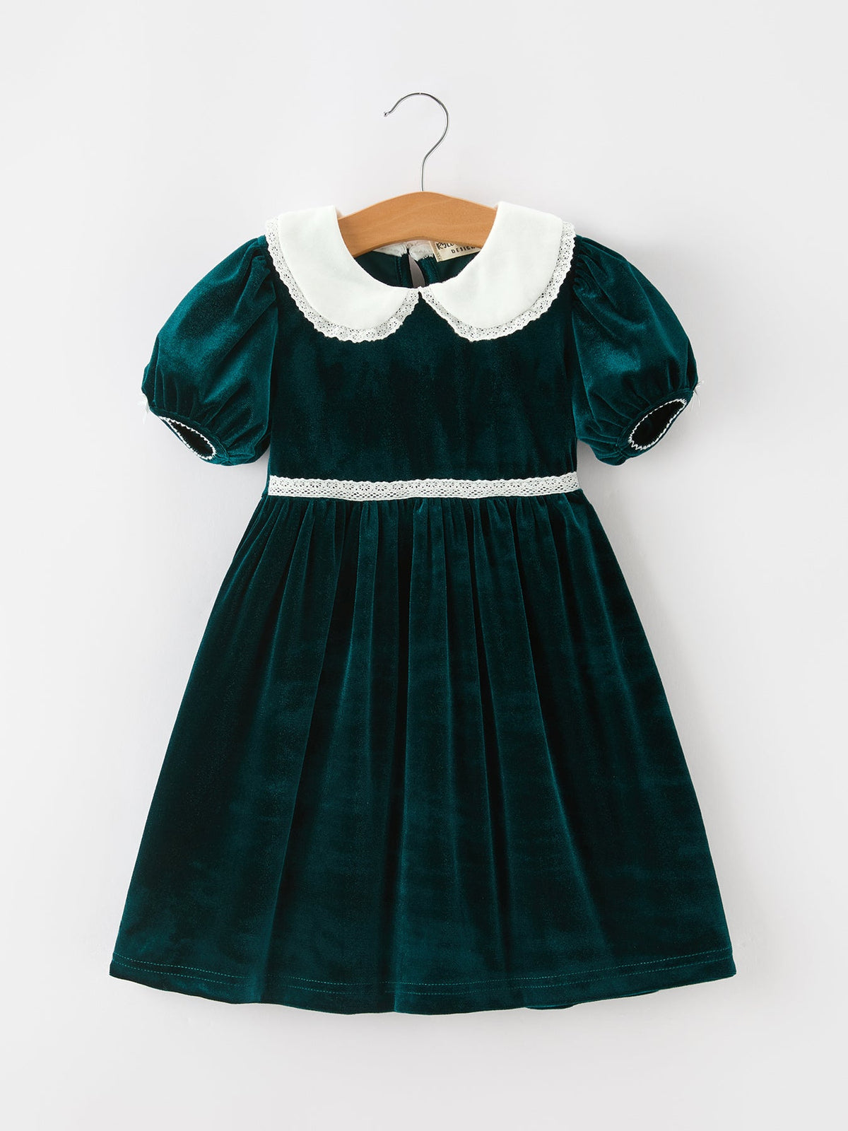 Girls emerald green velvet Christmas dress with white lace-trimmed Peter Pan collar, puff sleeves and gathered skirt