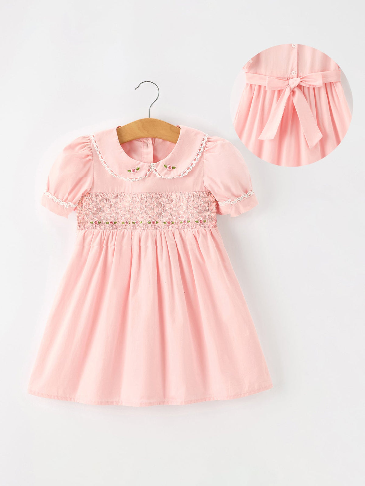 Soft pink girls dress with embroidered roses on a lace-trimmed Peter Pan collar, puff short sleeves, and smocked bodice