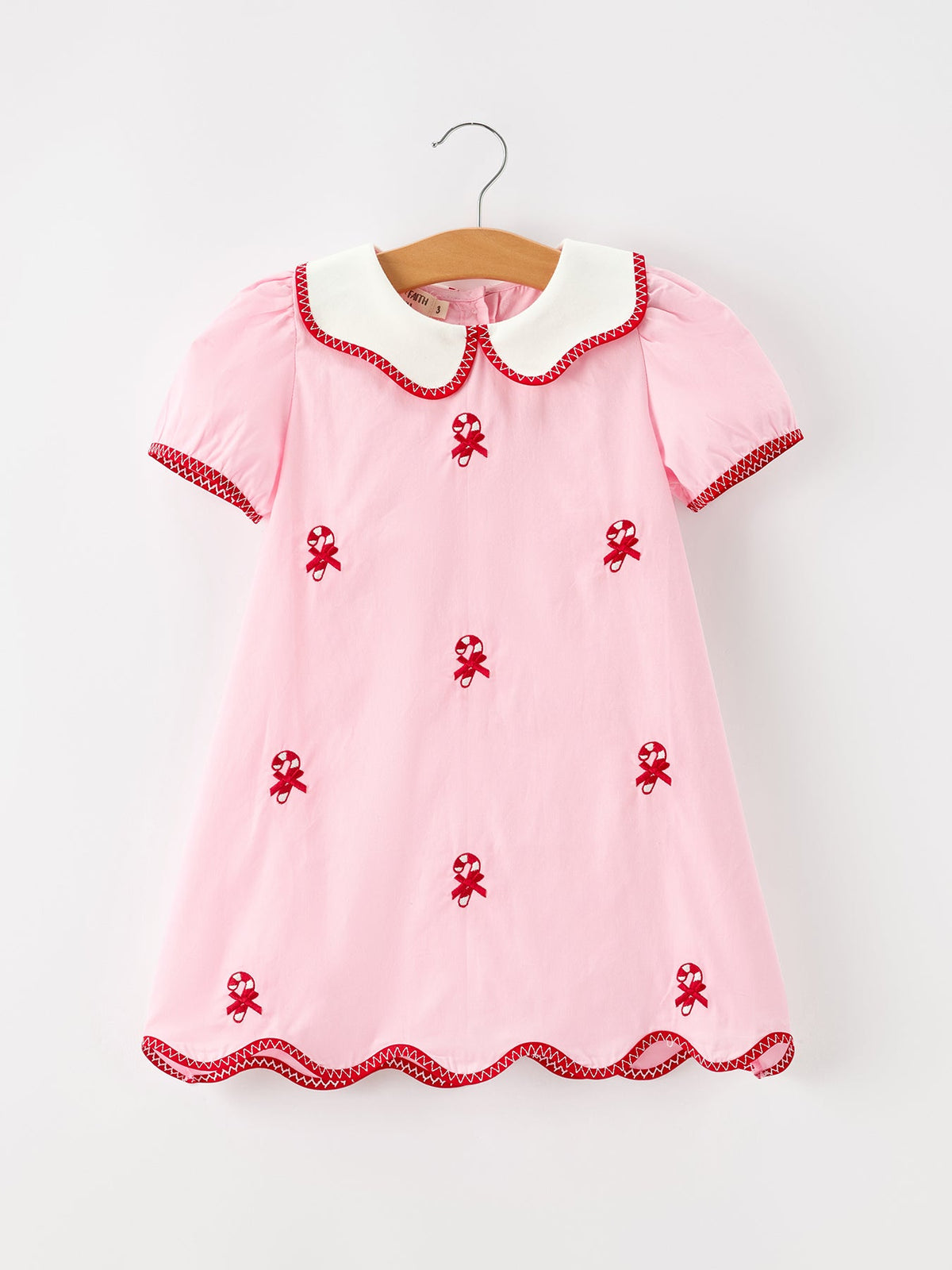 Pink girls Christmas dress with candy cane embroidery, white Peter Pan collar, short puff sleeves and scalloped hem