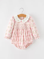 Baby girl romper in pink bow and floral print with embroidered scalloped collar, smocked chest, long sleeves and ruffle cuffs
