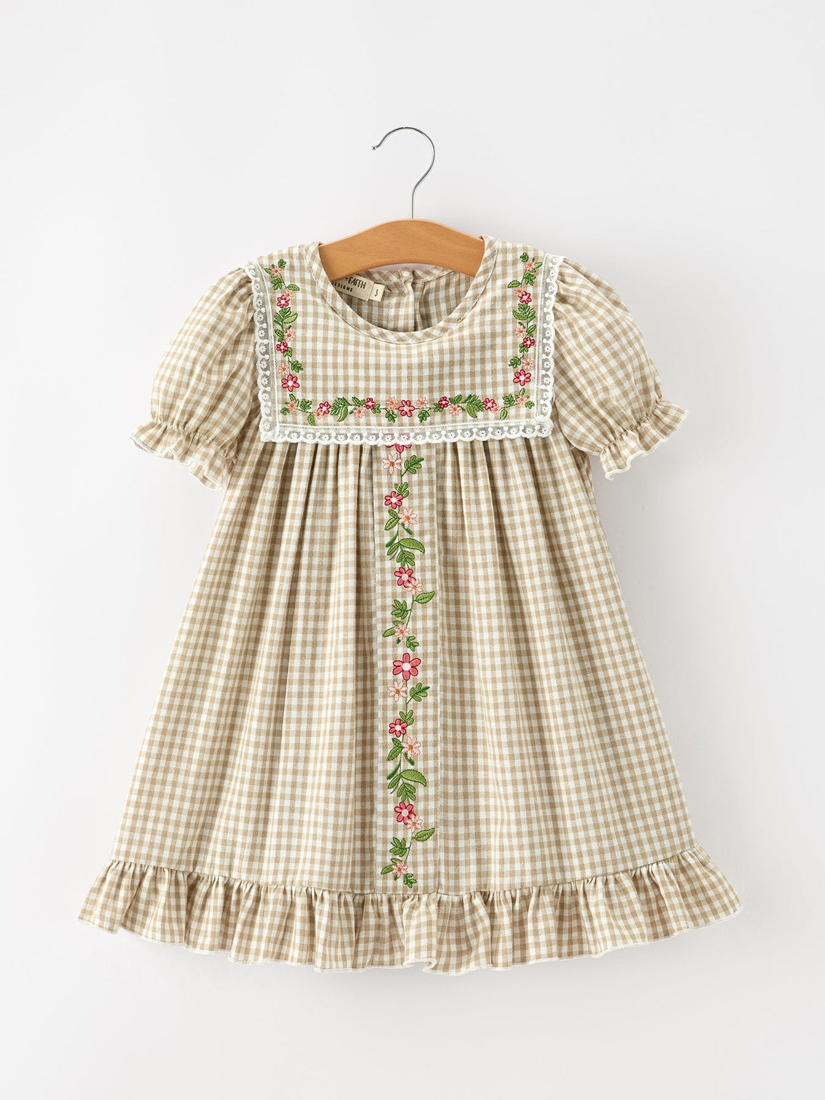 Girls khaki plaid dress with floral embroidered bib front, white lace trim, puff sleeves and ruffled hem