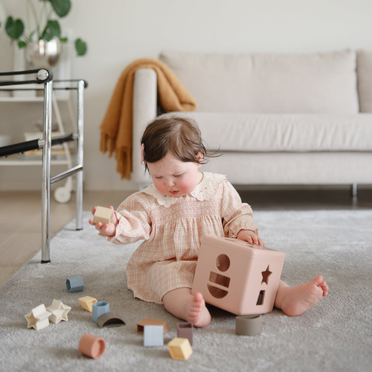 Mushie Shape Sorting Box, a natural baby learning toy.