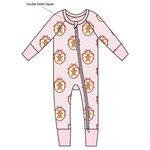 Pink gingerbread-print baby footed pajamas with a full-length two-way zipper and fold-over feet