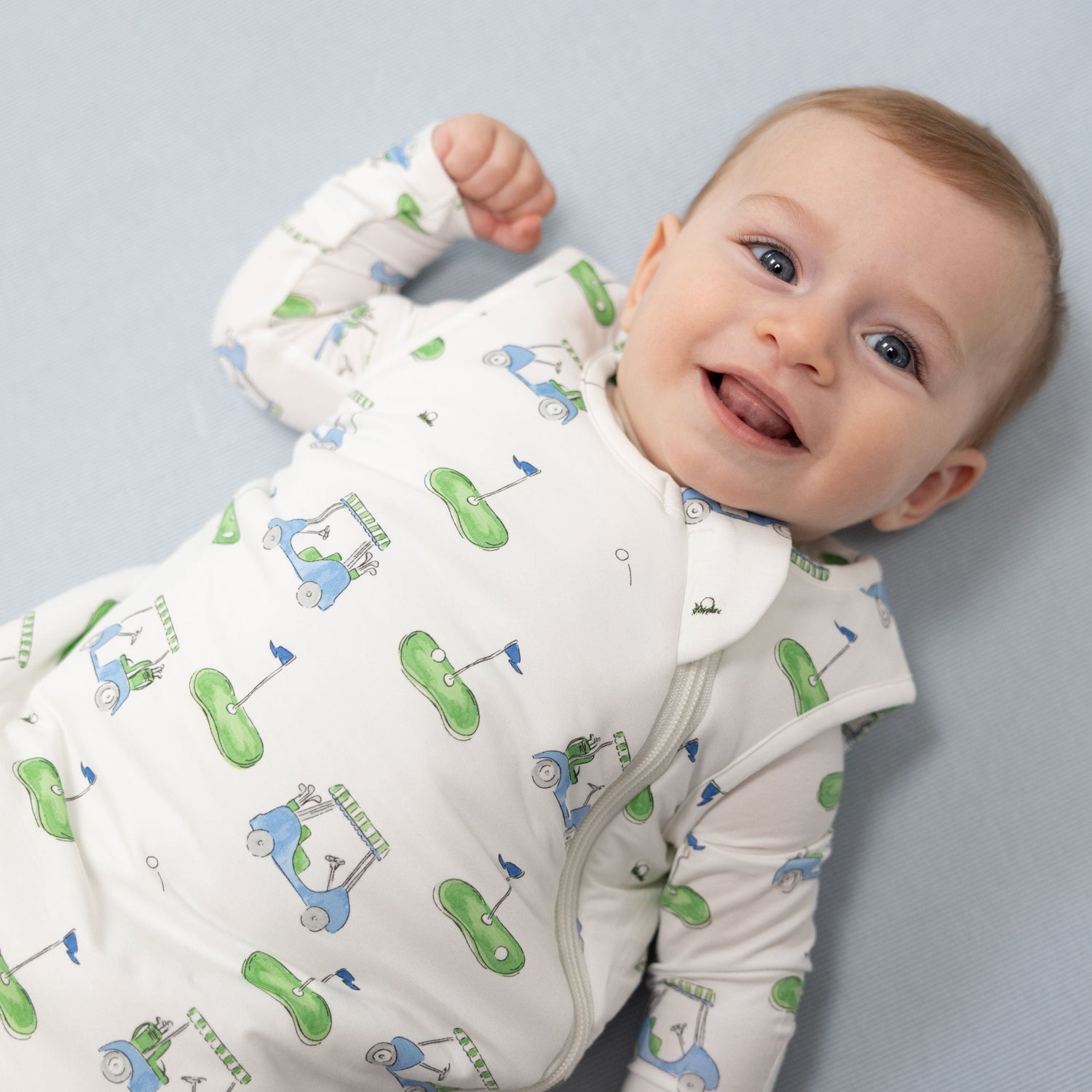 Sleep Bag in blue with a golf cart print and a two-way front zipper