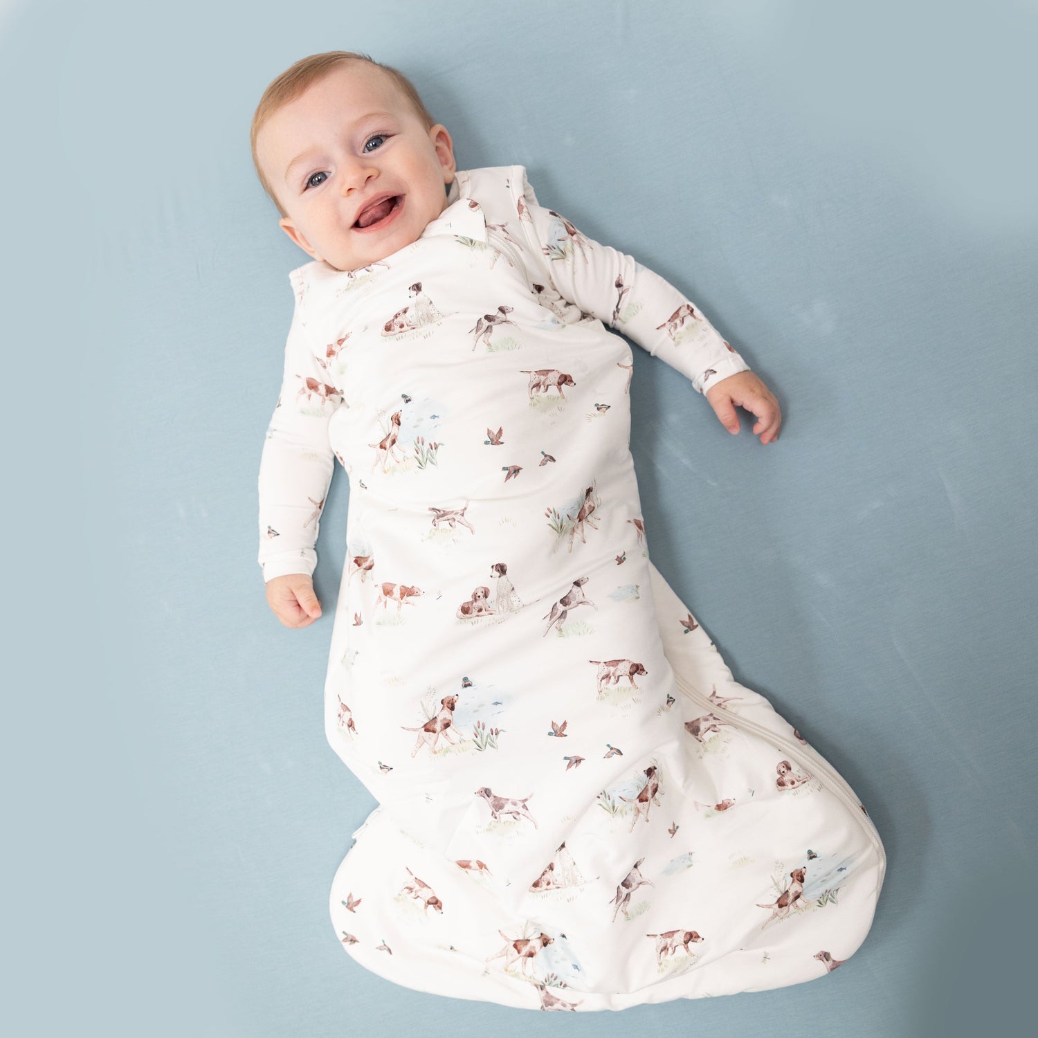 Baby sleep bag in a pointer pup and duck print with a 2-way front zipper