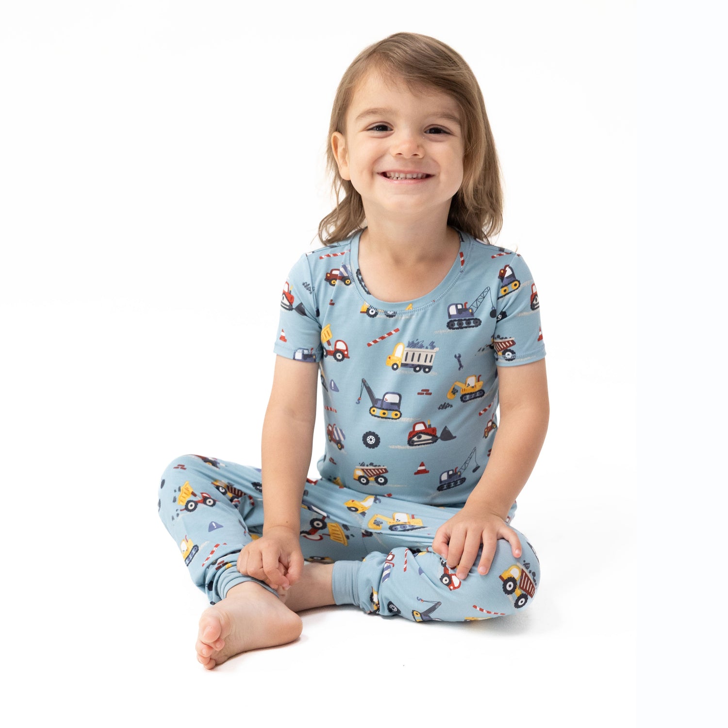 Short sleeve loungewear set with a crayon-drawn construction truck print on top and matching pull-on pants