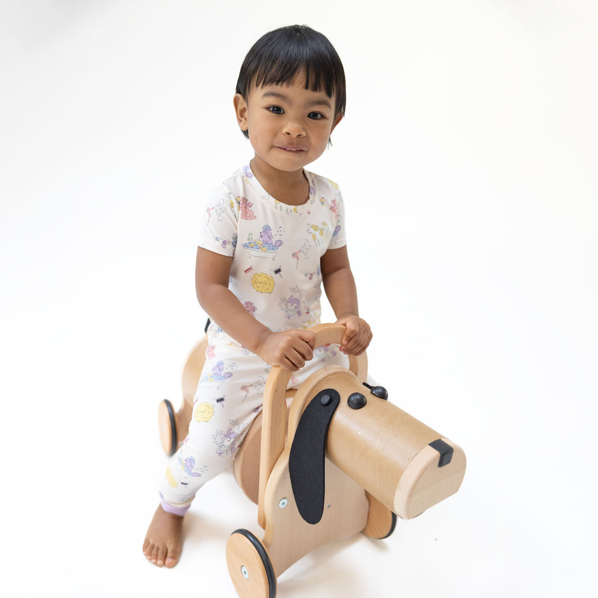 Two-piece short sleeve loungewear set with a spa dogs print, short-sleeve top and matching pull-on pants.