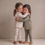 Two pairs of baby leggings, one winter berry red and one olive green