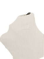 Close-up of a Little Mae & Co Coco Waffle Organic Car Seat Cover in a soft brown hue, draped over a car seat.