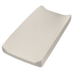 Close-up of a soft ivory coco waffle changing pad cover by Little Mae & Co. on a changing table.