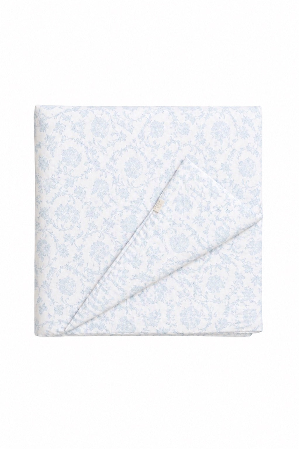 Quilted crib blanket in blue and white chinoiserie print, hand-tufted with a soft padded finish.
