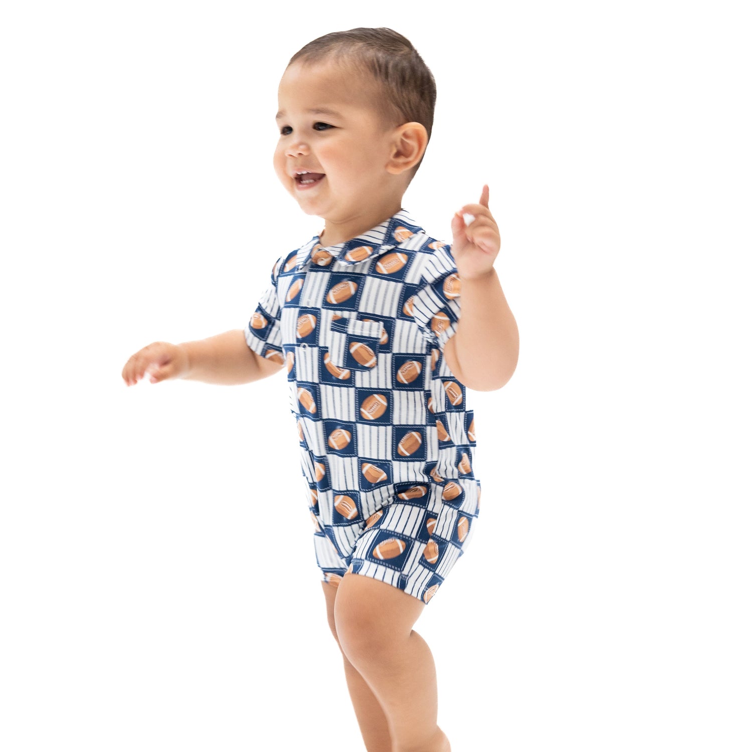 Baby polo shortie romper in a football patchwork print with collar, snap Henley placket, and short legs.