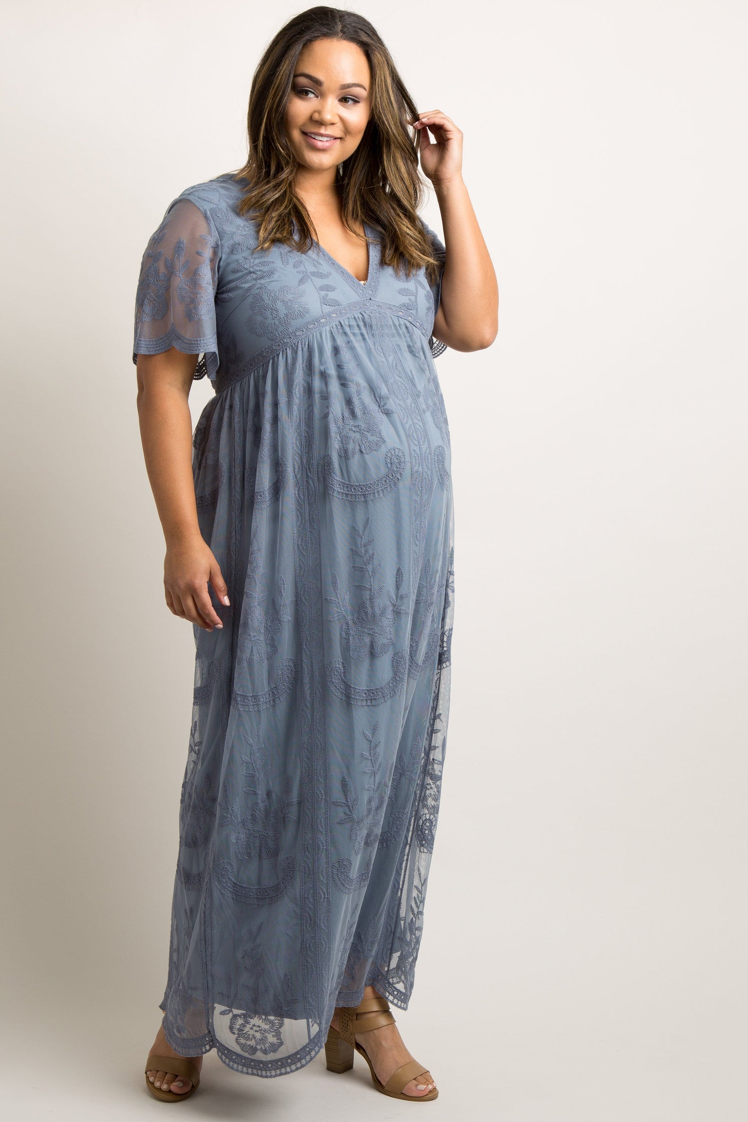 PinkBlush Plus size maternity maxi dress in blue with lace mesh overlay, modeled on a pregnant woman.