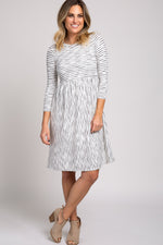 Ivory ribbed striped midi dress with pleated skirt, cinched waist, 3/4 sleeves and a rounded neckline.