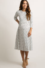 Ivory ribbed maternity midi dress with subtle stripes, short sleeves, and a fitted silhouette