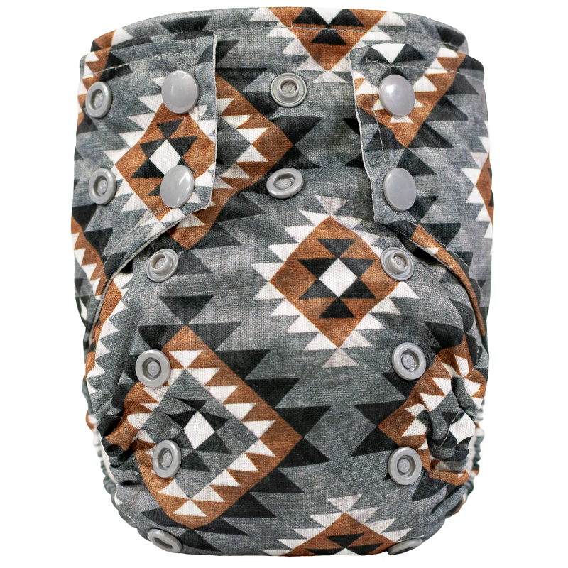 Tiny Tushies Newborn AIO Cloth Diaper with geometric pattern and snaps for secure fit.