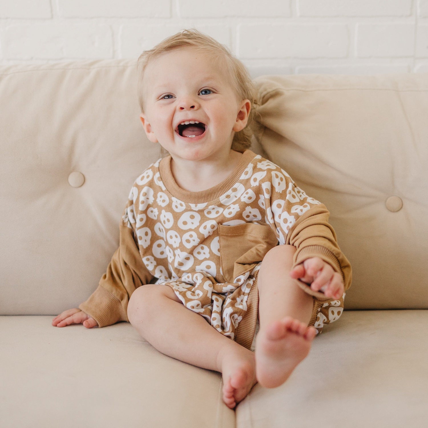 Bubble romper with Halloween skulls graphic print and a chest pocket, shown in an oversized fit.