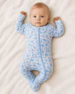 Baby footie pajamas in blue floral print with two-way zipper and covered feet