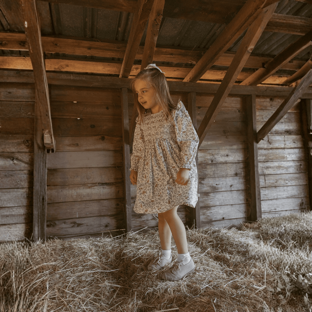 Ivy green baby dress with smocked bodice and ruffle details