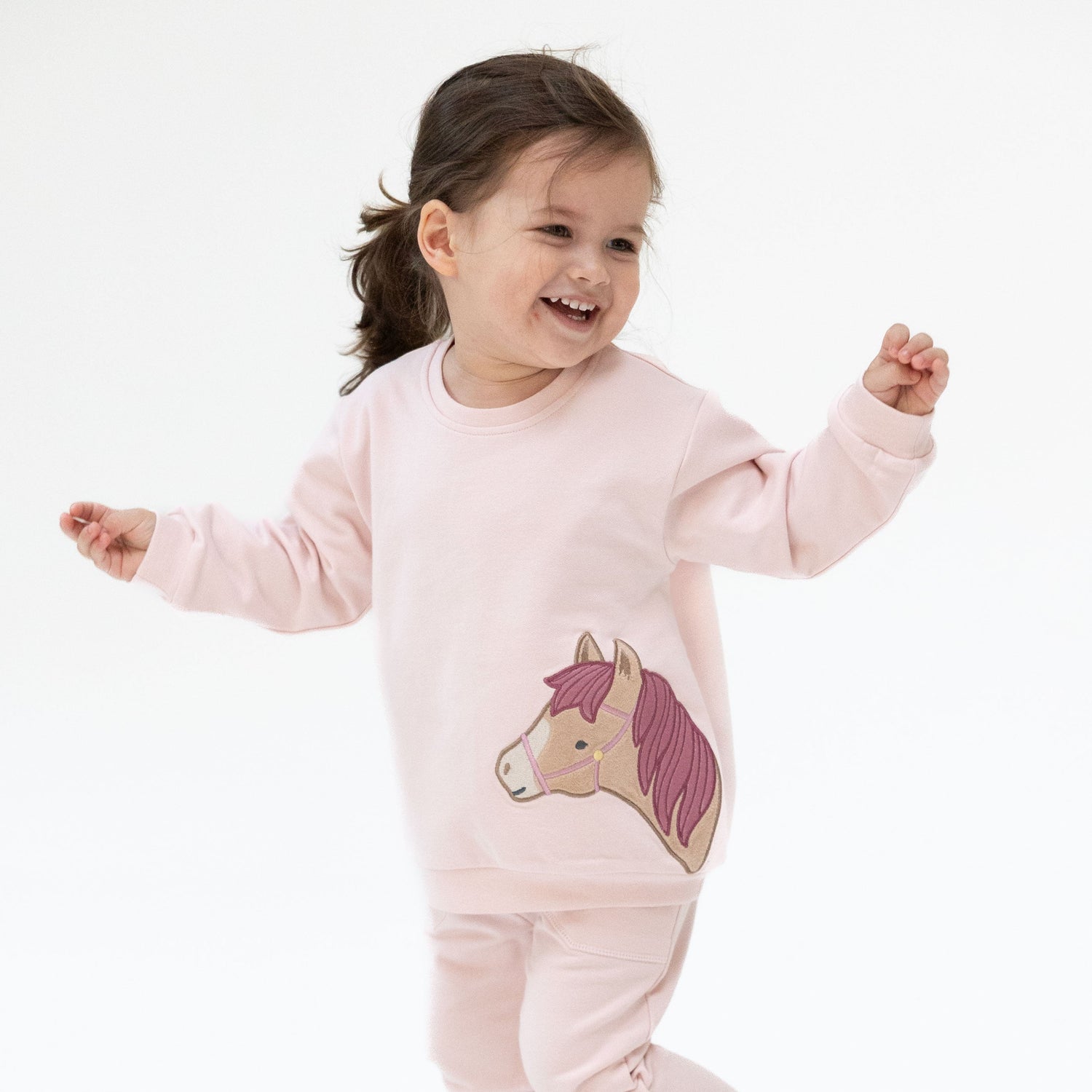 Soft pink oversized sweatshirt with a horse head applique
