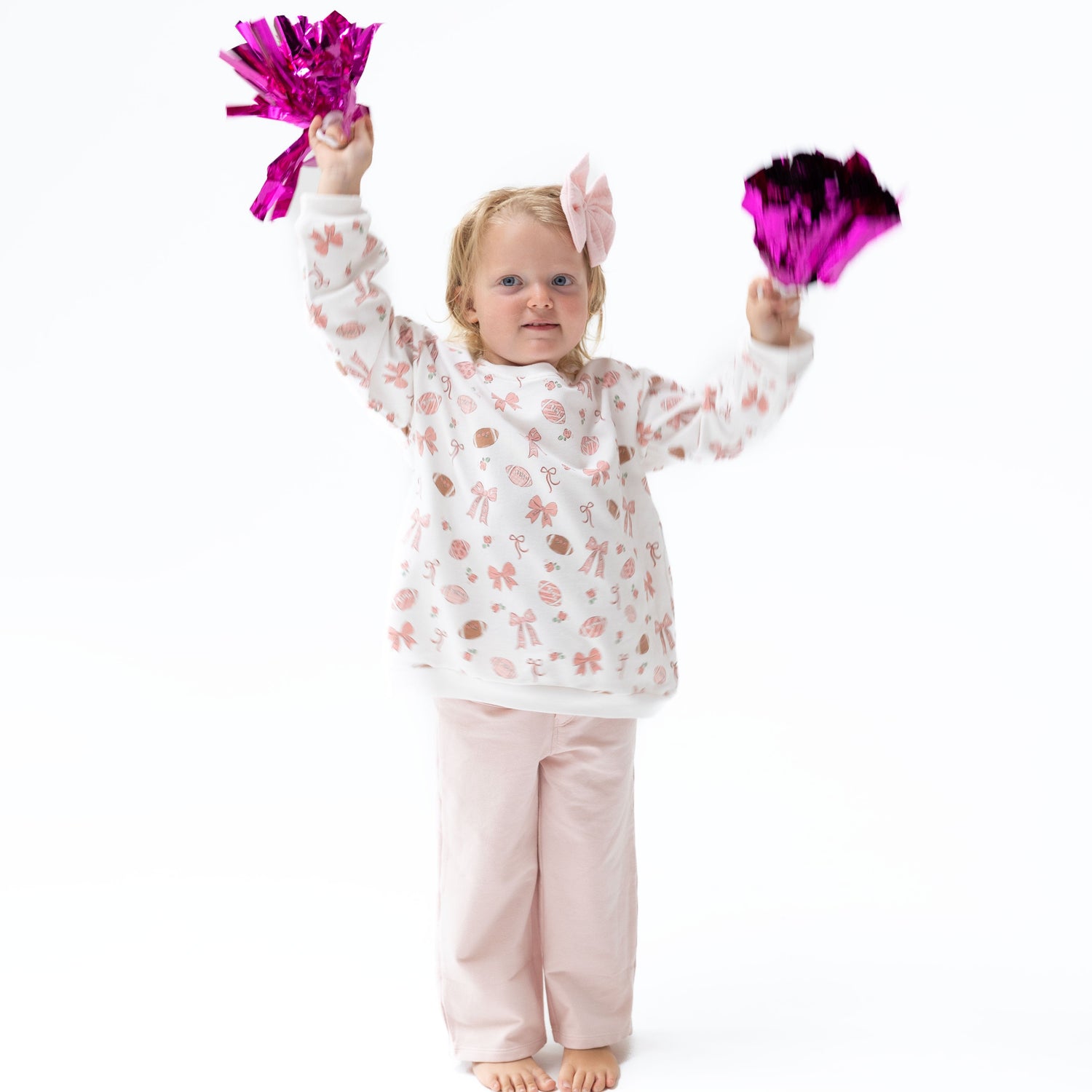 Baby two-piece set with football and bows print sweatshirt and matching flared baby bell pants.