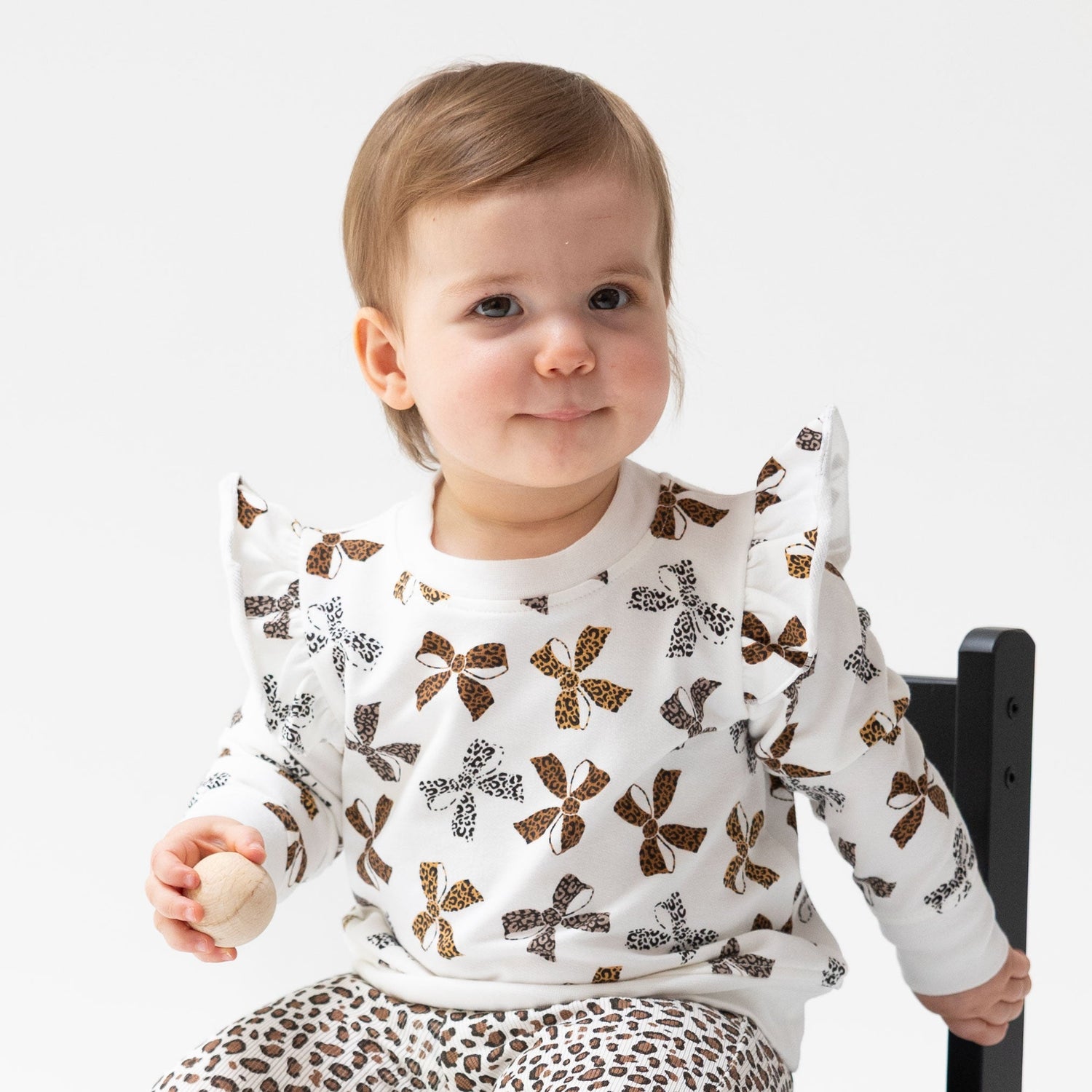 Baby sweatshirt in leopard print with ruffle trim detailing along the front.
