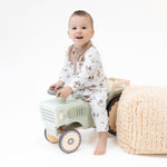 Long sleeve baby romper in a scattered horse print, laid flat with snap closures along the front