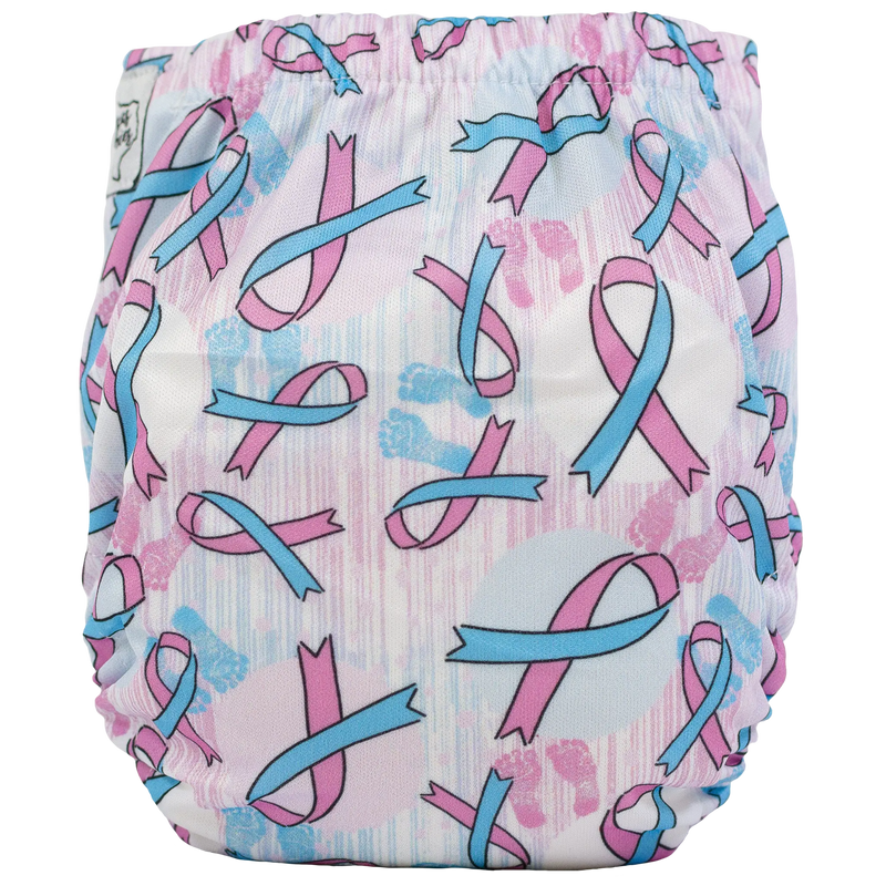 Tiny Tushies Newborn AIO Cloth Diaper with pink and blue ribbon design.
