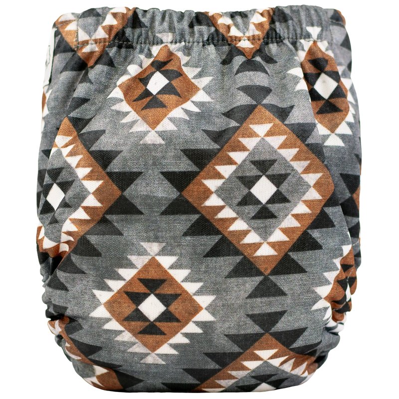 Tiny Tushies Newborn AIO cloth diaper with geometric pattern.