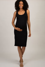 Black sleeveless ribbed maternity dress with rounded neckline, ruched sides, and knee-length hem, styled with heels