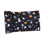 Swaddle blanket with a Halloween skeleton buddies print on a light background