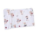 Swaddle blanket with a mixed sports bears print, showing bears with balls scattered across a light background