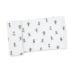 Swaddle blanket with a scattered tiny football players print