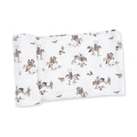 Swaddle blanket in a horse print with horses scattered across a soft background