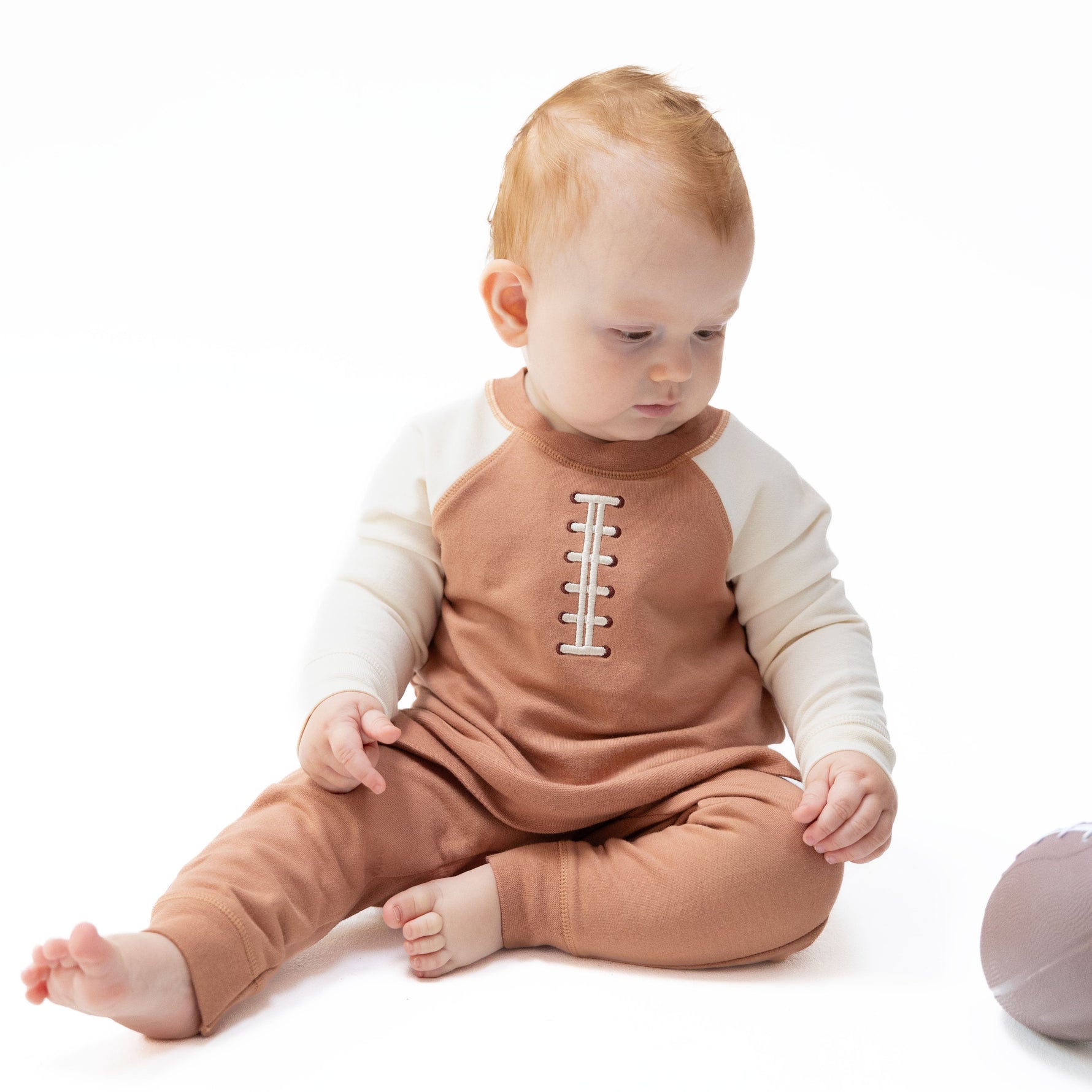 Raglan sweatshirt with football laces applique and matching joggers set for a baby.