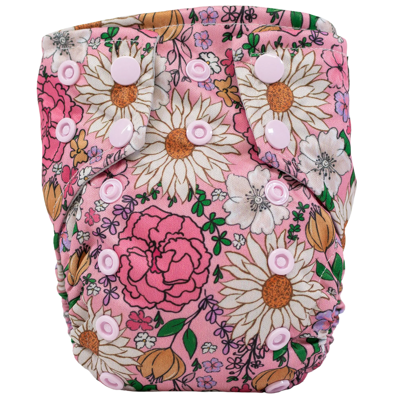 Tiny Tushies Newborn AIO Cloth Diaper with floral print and pink snaps.