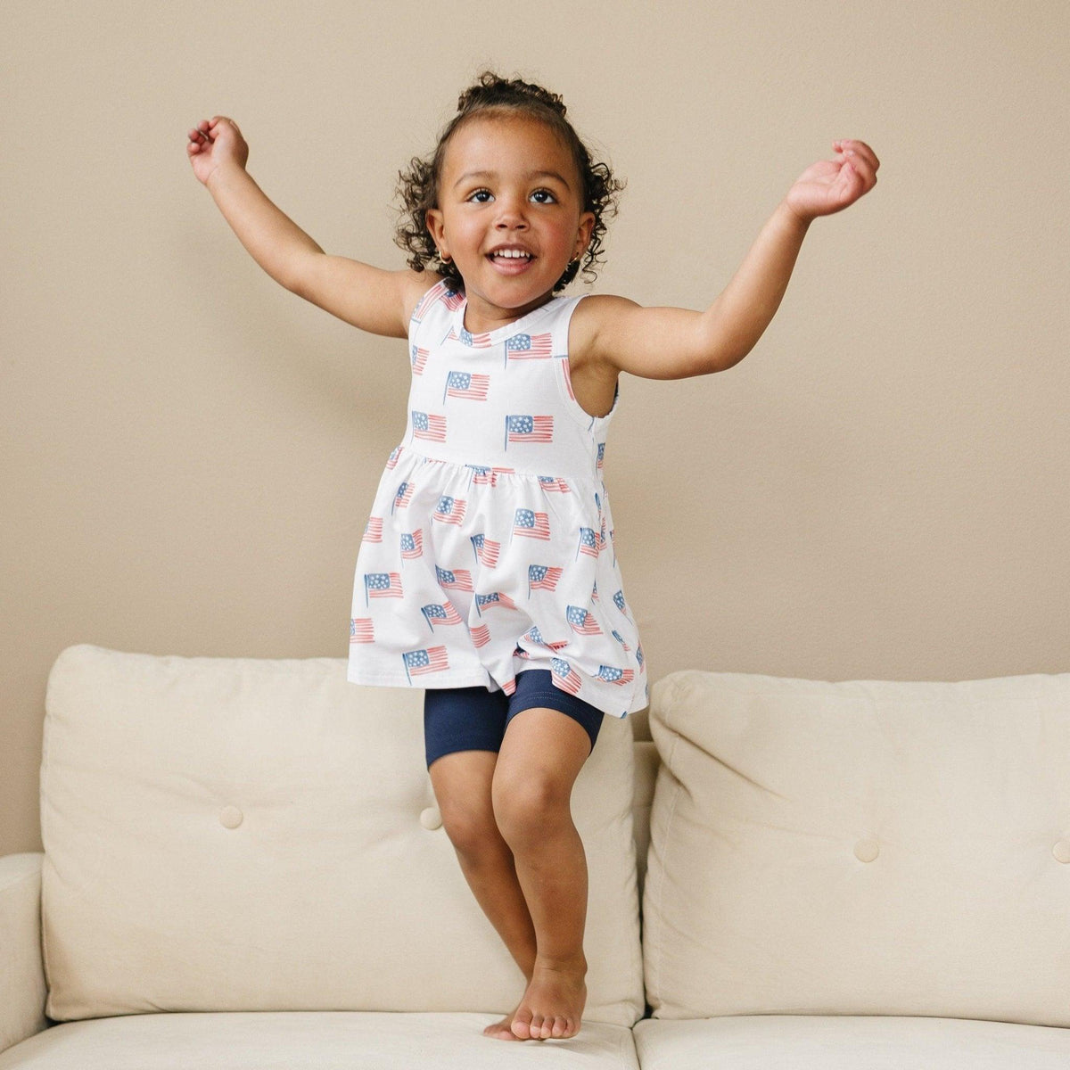 Little Joy Co. baby wearing a soft bamboo tee and bike shorts set, smiling and playing