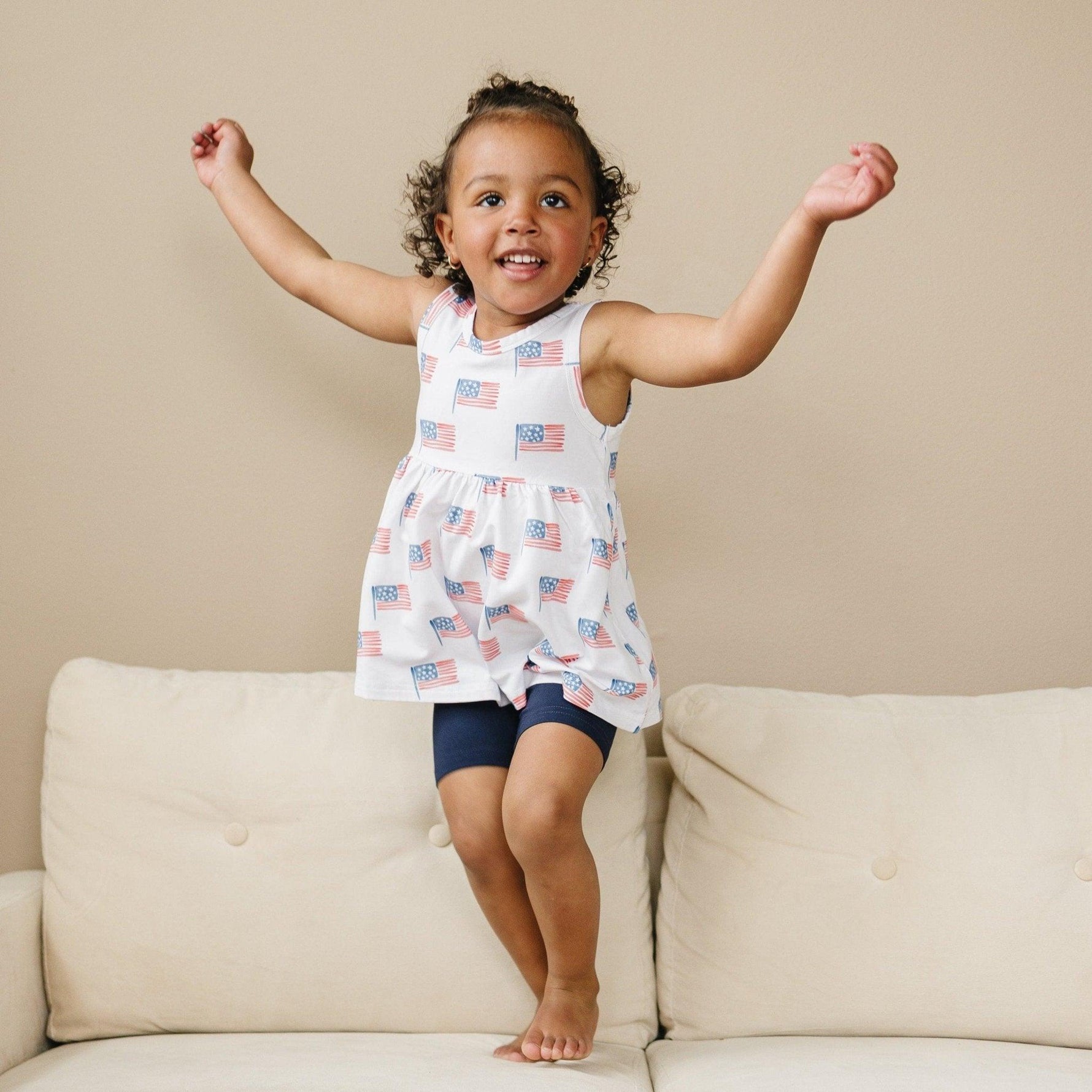 Little Joy Co. baby wearing a soft bamboo tee and bike shorts set, smiling and playing