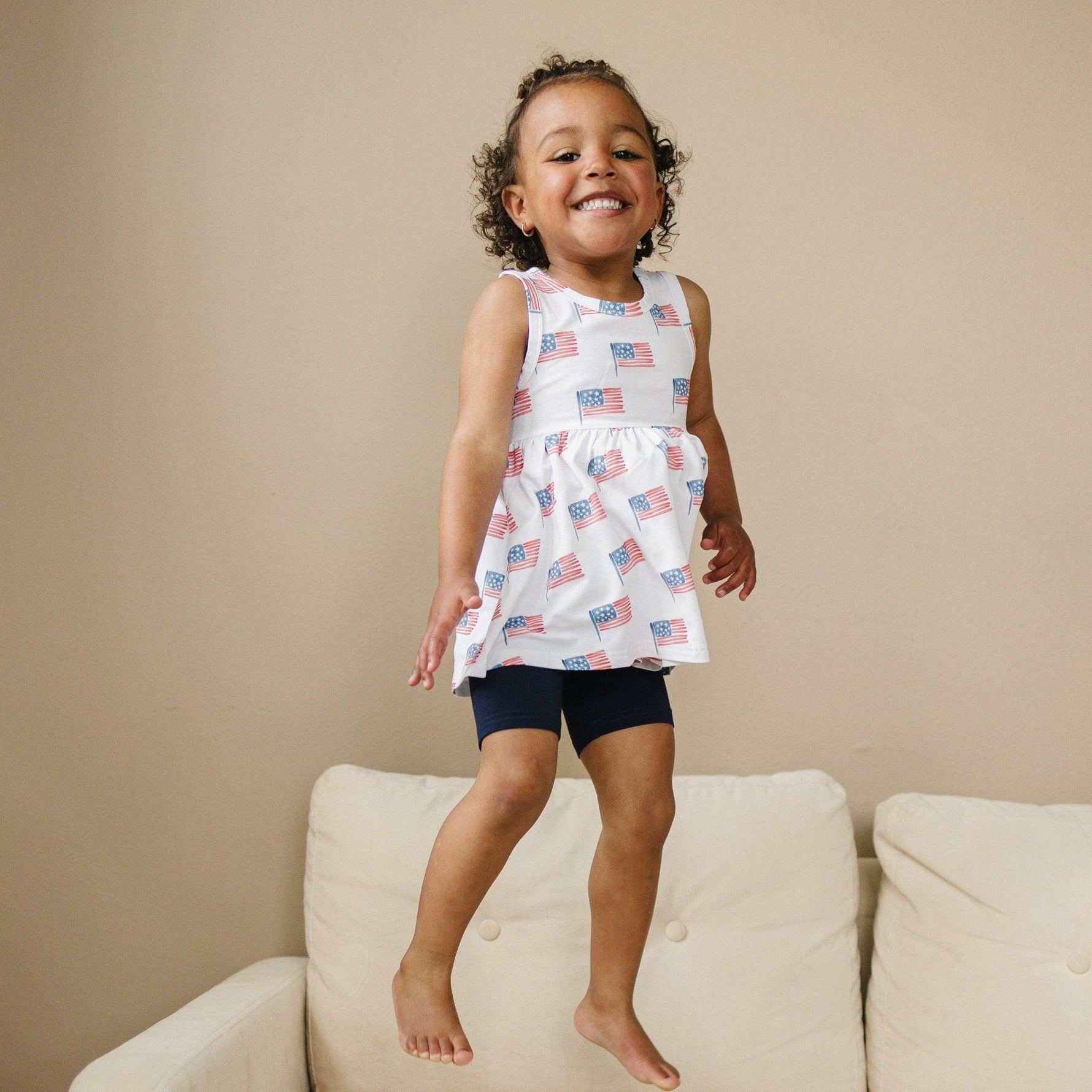 Little Joy Co. baby wearing a soft bamboo tee and bike shorts set, smiling and playing