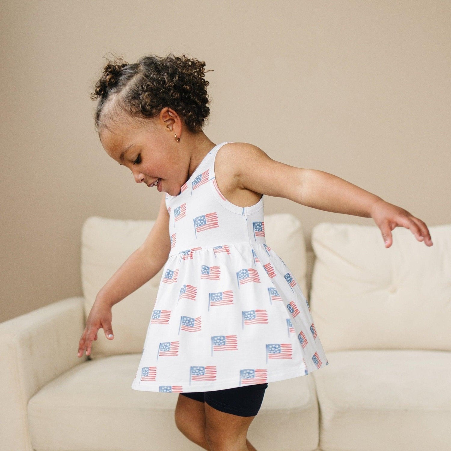 Little Joy Co. baby wearing a soft bamboo tee and bike shorts set, smiling and playing