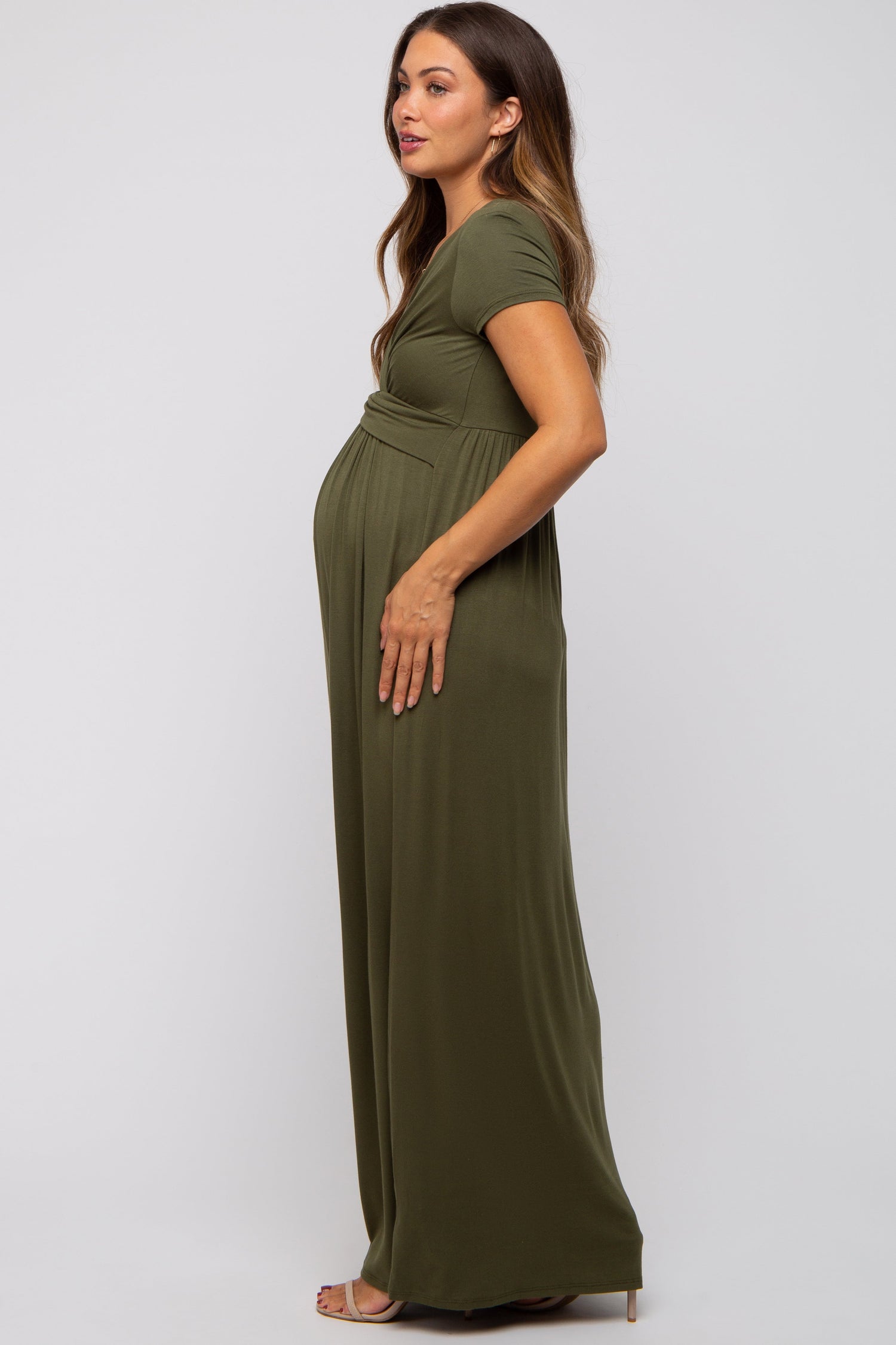 Woman wearing PinkBlush olive draped maternity nursing maxi dress, smiling, showing draped detail