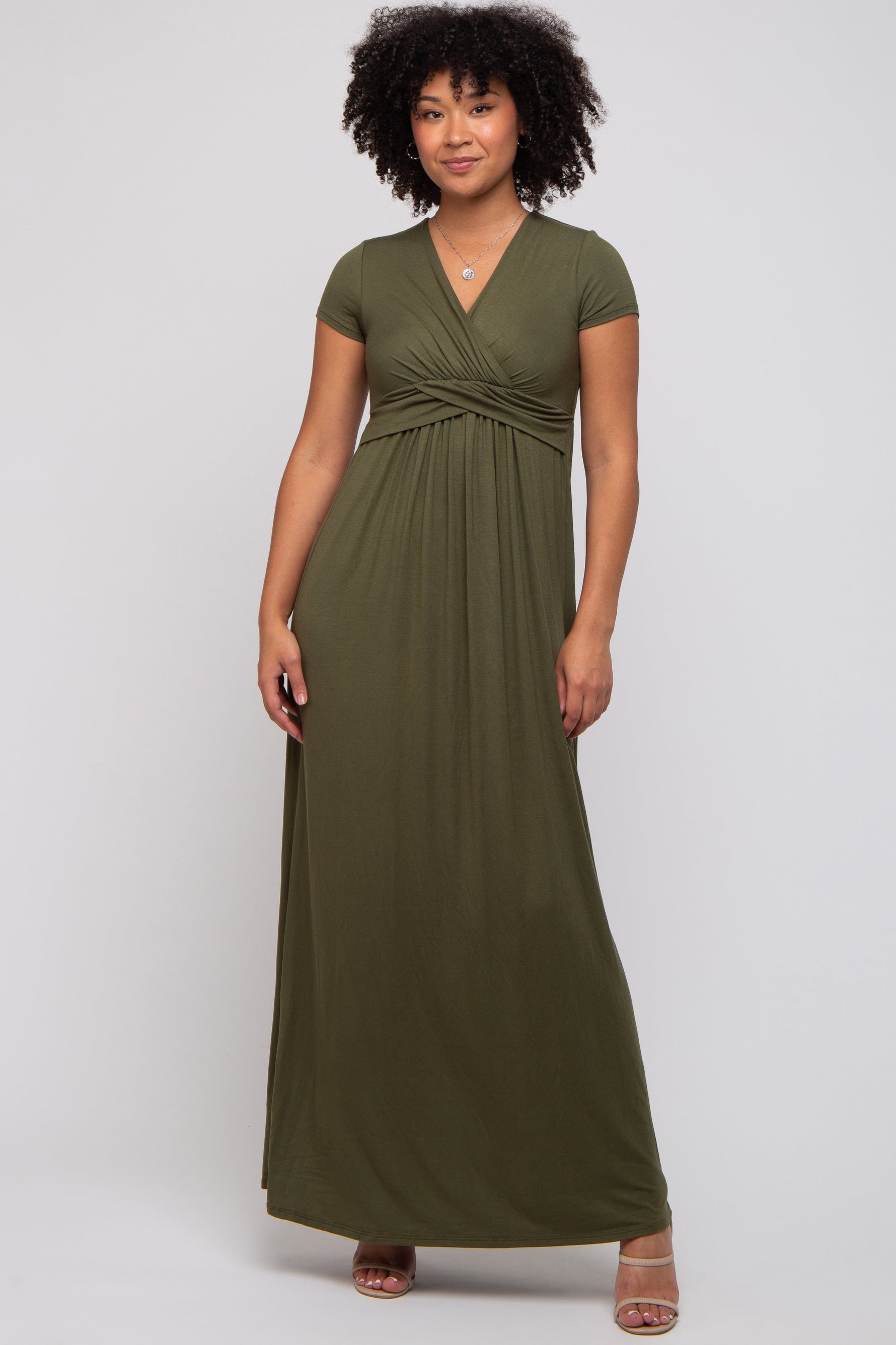 Woman wearing PinkBlush olive draped maternity nursing maxi dress, smiling, showing draped detail