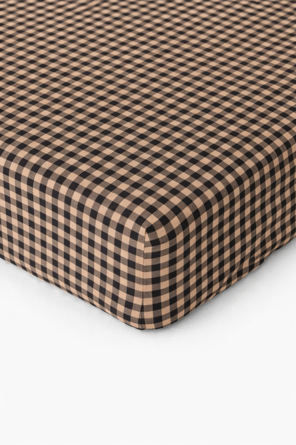 Cookie brown and white gingham pattern organic cotton crib sheet by Little Mae & Co for a baby's crib.