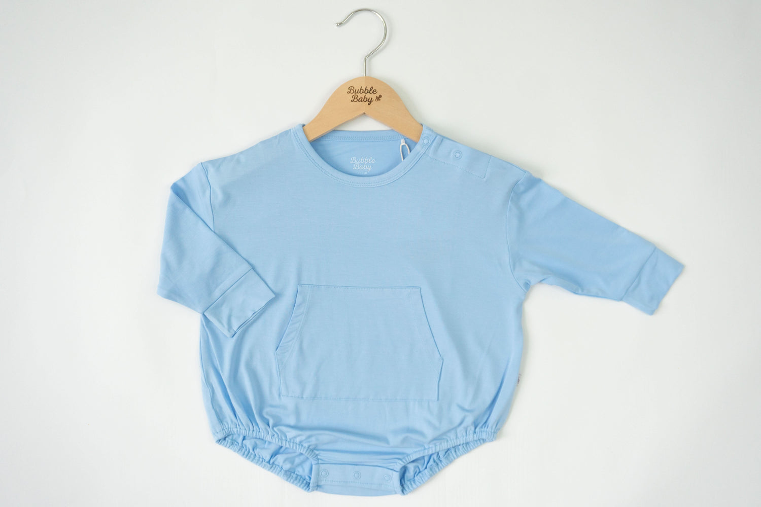Long sleeve bubble romper in a light sky blue with snap neck and snap diaper closures
