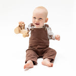 Baby overalls in beaver brown corduroy with adjustable shoulder straps, front bib pocket and side pockets