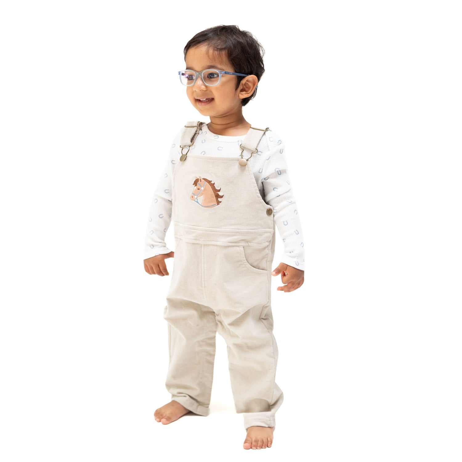 Tan peyote corduroy baby overall with horse head applique on the front and a muslin bandana in the back pocket