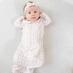 Kimono gown and knotted hat set in a rosebud stripe pattern with snap closures.
