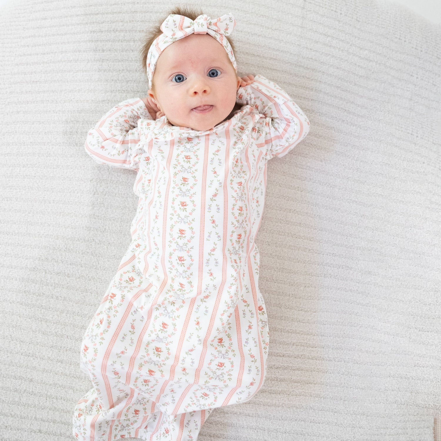 Kimono gown and knotted hat set in a rosebud stripe pattern with snap closures.